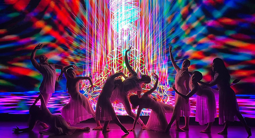 Photo Depicting Dancers in front of vibrant lights