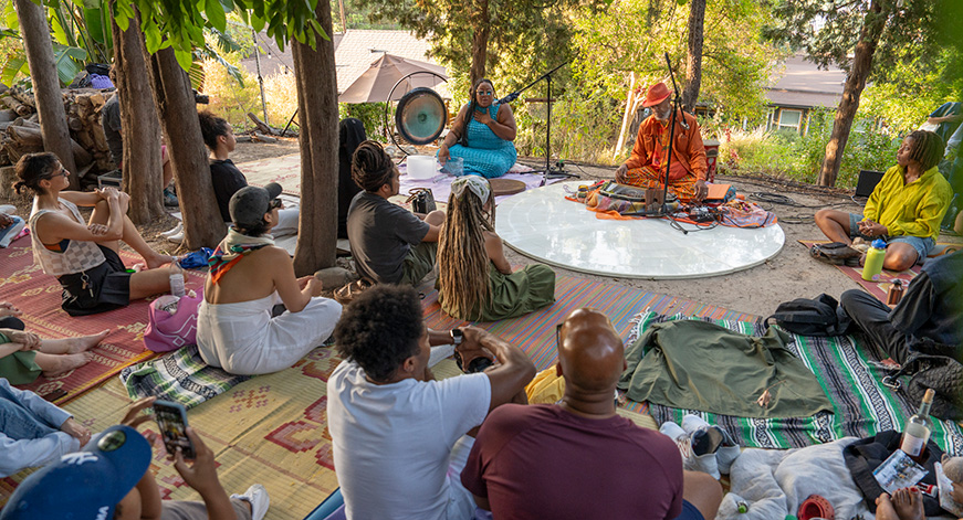 Photo depicting a perforamnce featuring Artist Adee Roberson in a natural setting