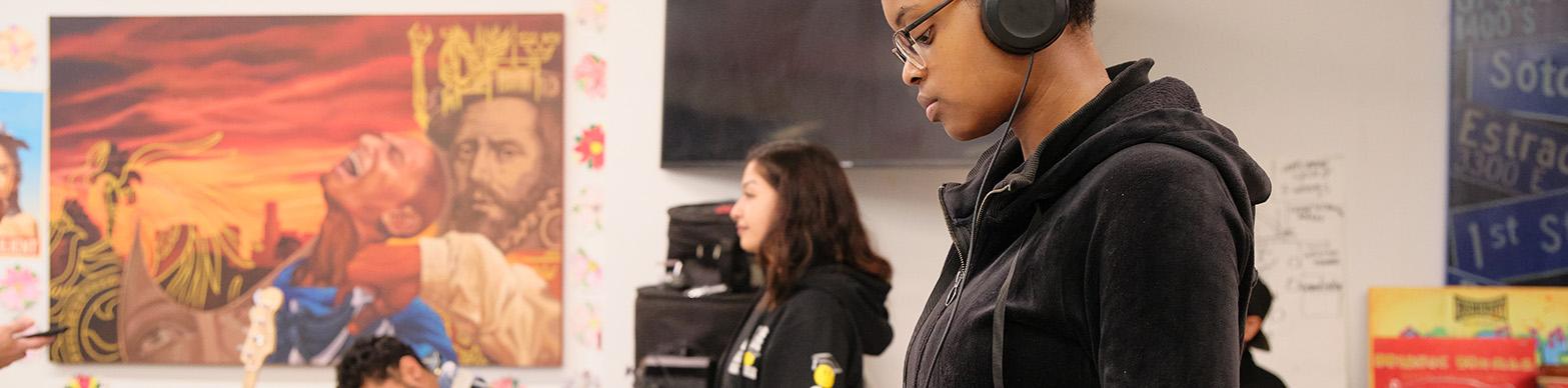 Young black woman sound mixing on a computer
