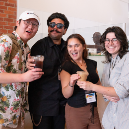 Four interns pose with coffees